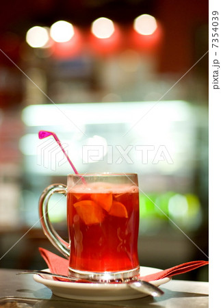 Cup of fruit tea on abstract blurred background (shallow DoF) 7354039