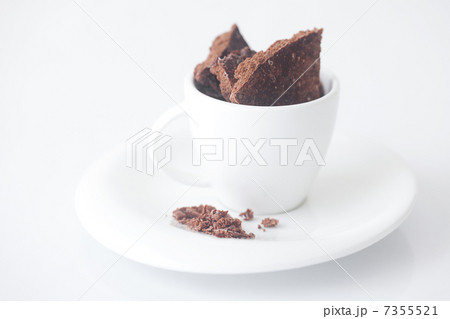 white cup with saucer and chocolate 7355521
