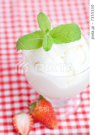 ice cream,strawberry with mint in a glass bowl on plaid fabric ice cream,strawberry with mint in a glass bowl on plaid fabric 7355530