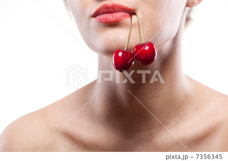 Young woman with cherry isolated on white 7356345