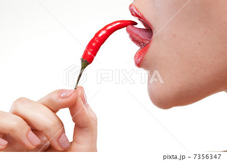 Young woman with chili pepper isolated on white 7356347