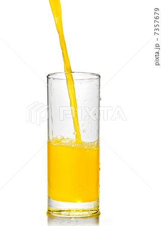 orange juice poring into glass isolated on white orange juice poring into glass isolated on white 7357679