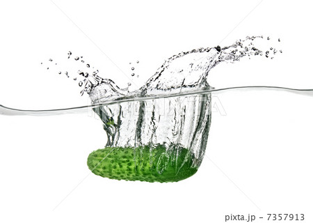 green cucumber dropped into water isolated on white 7357913