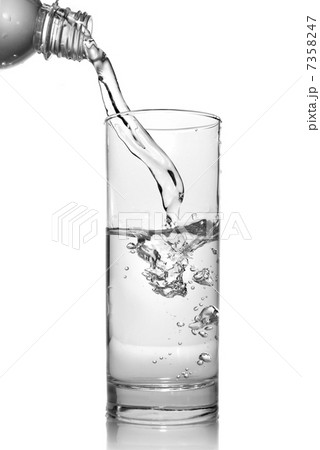 water pouring into glass from bottle isolated on white water pouring into glass from bottle isolated on white 7358247