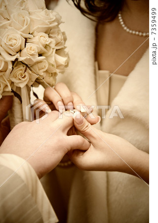 puttting on a wedding ring. stylized photo puttting on a wedding ring. stylized photo 7359499