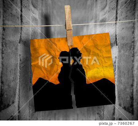 Torn photo of couple hung with a peg on a line 7360267