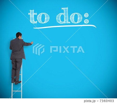 Businessman writing to do list on a blue wall 7360403