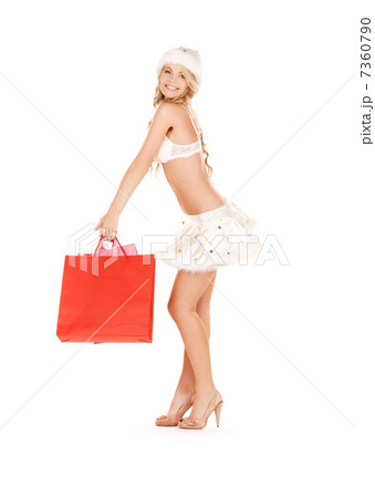 cheerful santa helper with shopping bags 7360790