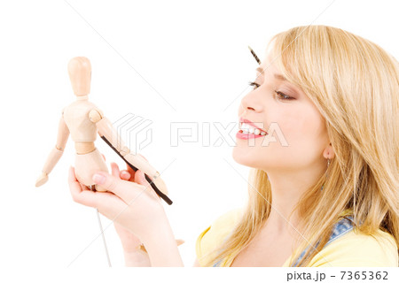 happy teenage girl with wooden model dummy happy teenage girl with wooden model dummy 7365362