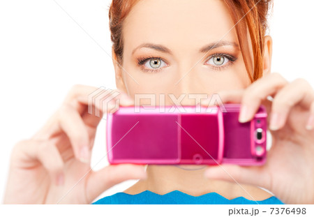 redhead woman using phone camera redhead woman using phone camera 7376498