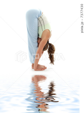 uttanasana standing forward bend on white sand 7377430