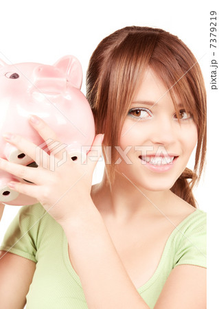lovely teenage girl with piggy bank 7379219