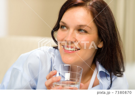 Smiling brunette woman with glass of water 7380870
