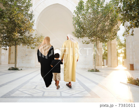 Muslim arabic traditional oriental family walking together, beautiful ambient in front of the mosque 7381011