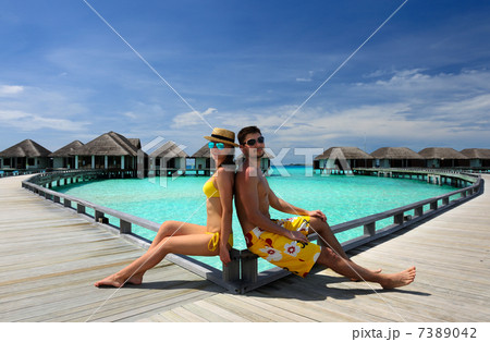Couple on a beach jetty at Maldives 7389042