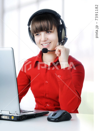 A friendly secretary/telephone operator in an office environment. 7391182
