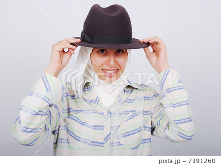 A young muslim woman in traditional clothes with a hat 7391260