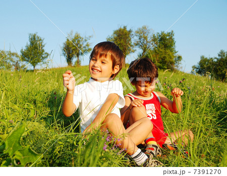 Little cute children on beautiful green field Little cute children on beautiful green field 7391270
