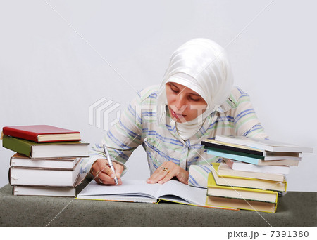 A young muslim woman in traditional clothes in education process A young muslim woman in traditional clothes in education process 7391380