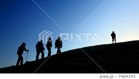 Group of tourists take to the mountains. Silhouette 7404743