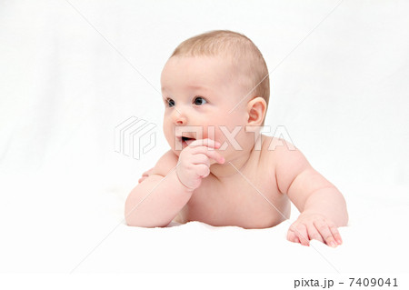 Beautiful happy baby lies on white blanket 7409041