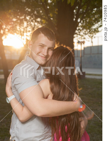 couple in backlit at sunset in park couple in backlit at sunset in park 7410985
