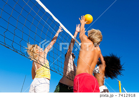 Friends playing beach volleyball Friends playing beach volleyball 7412918