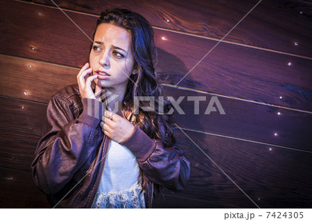 Frightened Pretty Young Woman in Dark Walkway at Night 7424305