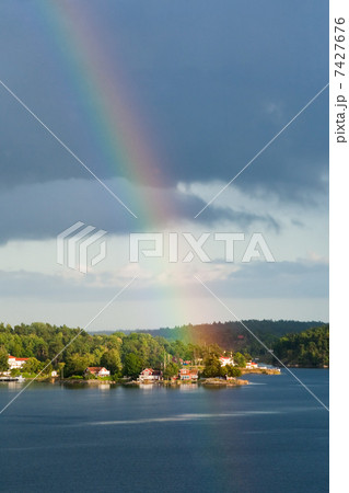 rainbow under small village on Baltic seashore 7427676