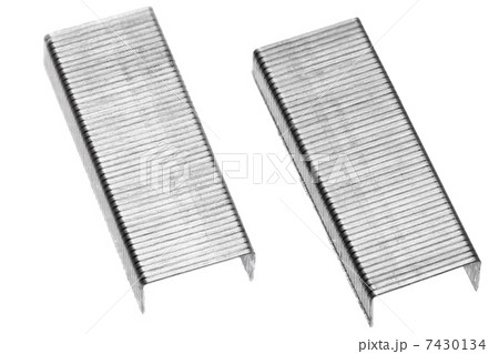 Stack of metal staples. Isolated on a white. Stack of metal staples. Isolated on a white. 7430134