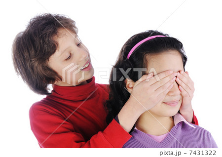 Girl covering a girls eyes to see if she can guess who is behind her 7431322