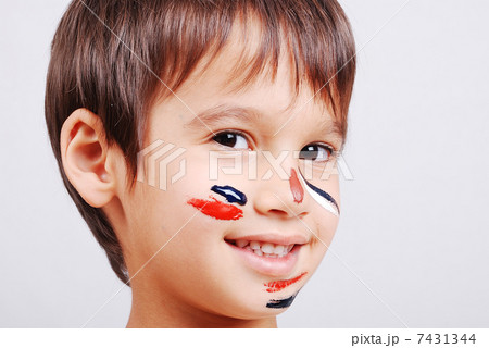 Little cute kid with colors on his face Little cute kid with colors on his face 7431344