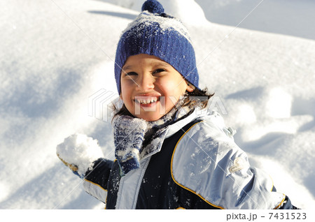 Happy smiling boy throwing snow to you 7431523