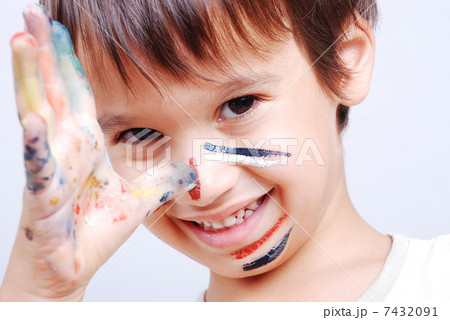 Little cute kid with colors on his face Little cute kid with colors on his face 7432091