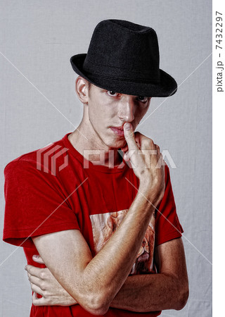 Young model with hat on head and thinking expression 7432297