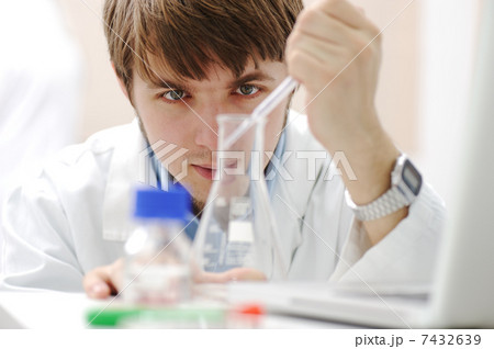 Young medical scientist working in modern lab, research with tubes and notebook Young medical scientist working in modern lab, research with tubes and notebook 7432639