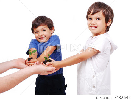 Little cute children holding green plant in hands Little cute children holding green plant in hands 7432642