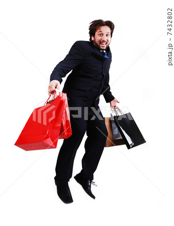 Young attractive bussinesman with shopping bags jumping 7432802