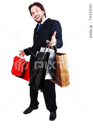 Young attractive man wearing suit and holding shopping bags Young attractive man wearing suit and holding shopping bags 7433050