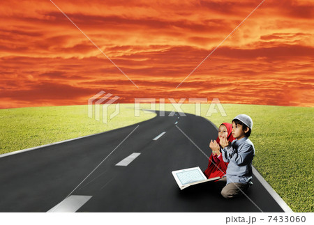 Two children sitting on road and reading Two children sitting on road and reading 7433060