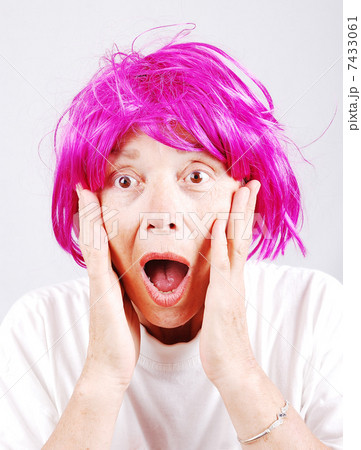 Senior woman with pink hair and facial gesture 7433061
