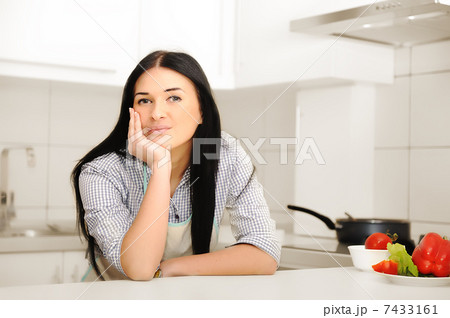Beautiful woman thinking in kitchen 7433161
