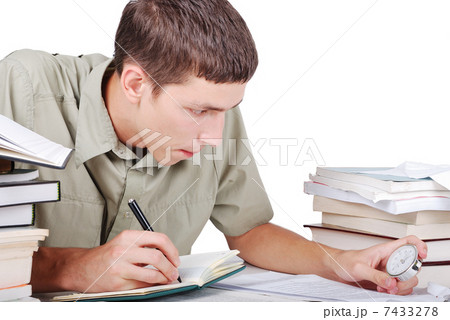 Young man writting on desk with books Young man writting on desk with books 7433278