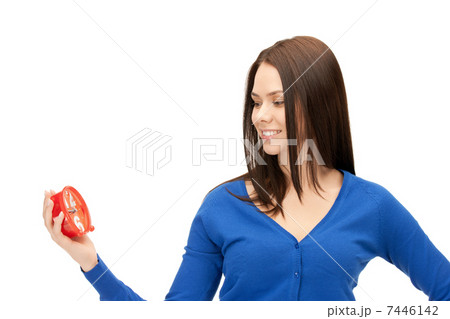 woman holding alarm clock 7446142