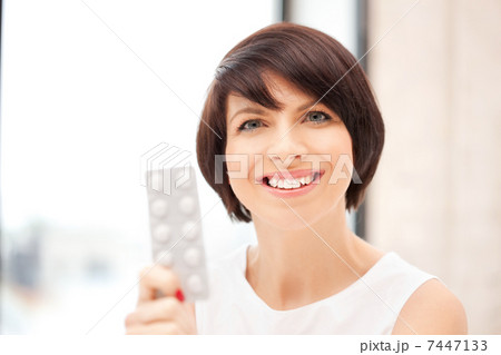 young beautiful woman with pills 7447133