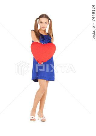 lovely woman with red heart-shaped pillow 7449124