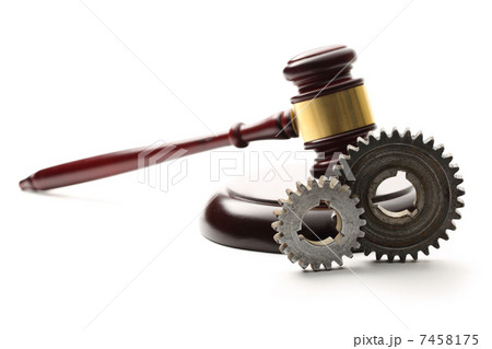 Steel cogwheels on judge's wooden gavel background Steel cogwheels on judge's wooden gavel background 7458175