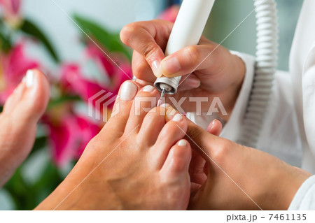 Woman in nail studio receiving pedicure 7461135
