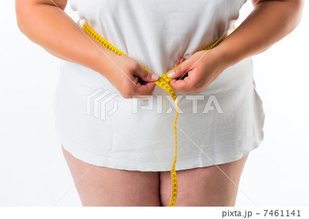 Woman measuring her waist with tape 7461141