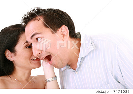 girl tells something into surprised guy's ear isolated on white girl tells something into surprised guy's ear isolated on white 7471082